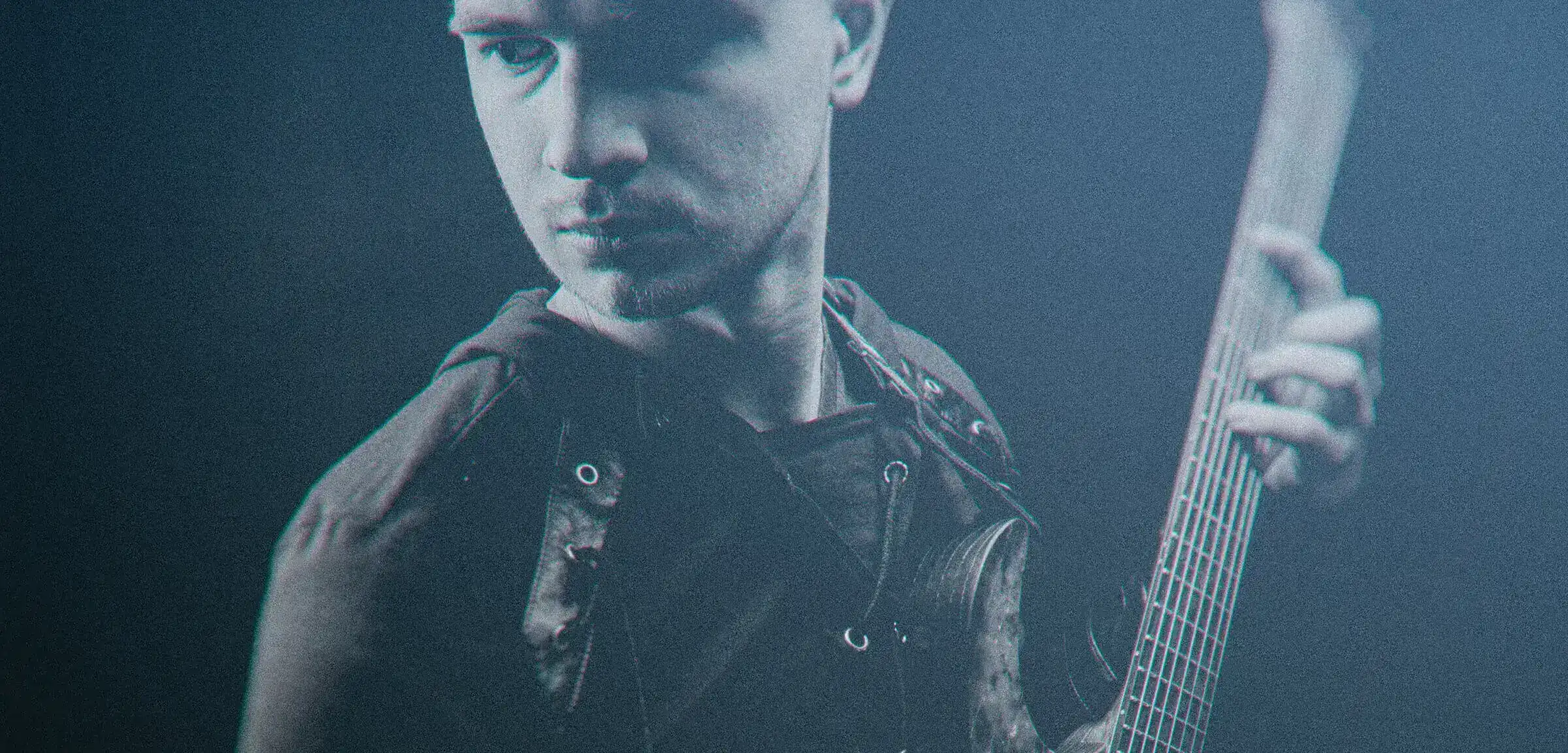 Wojciech Bator standing with guitar